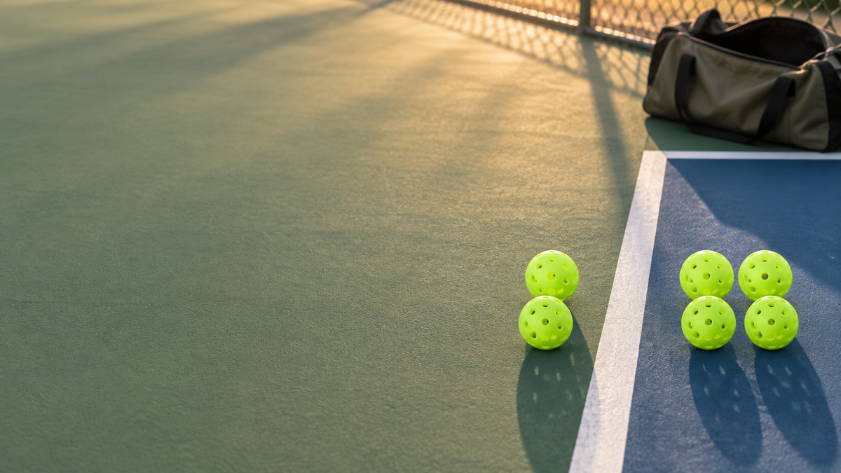 Editorial illustration of two versus four pickleball gear planning with six generic lime balls on a court
